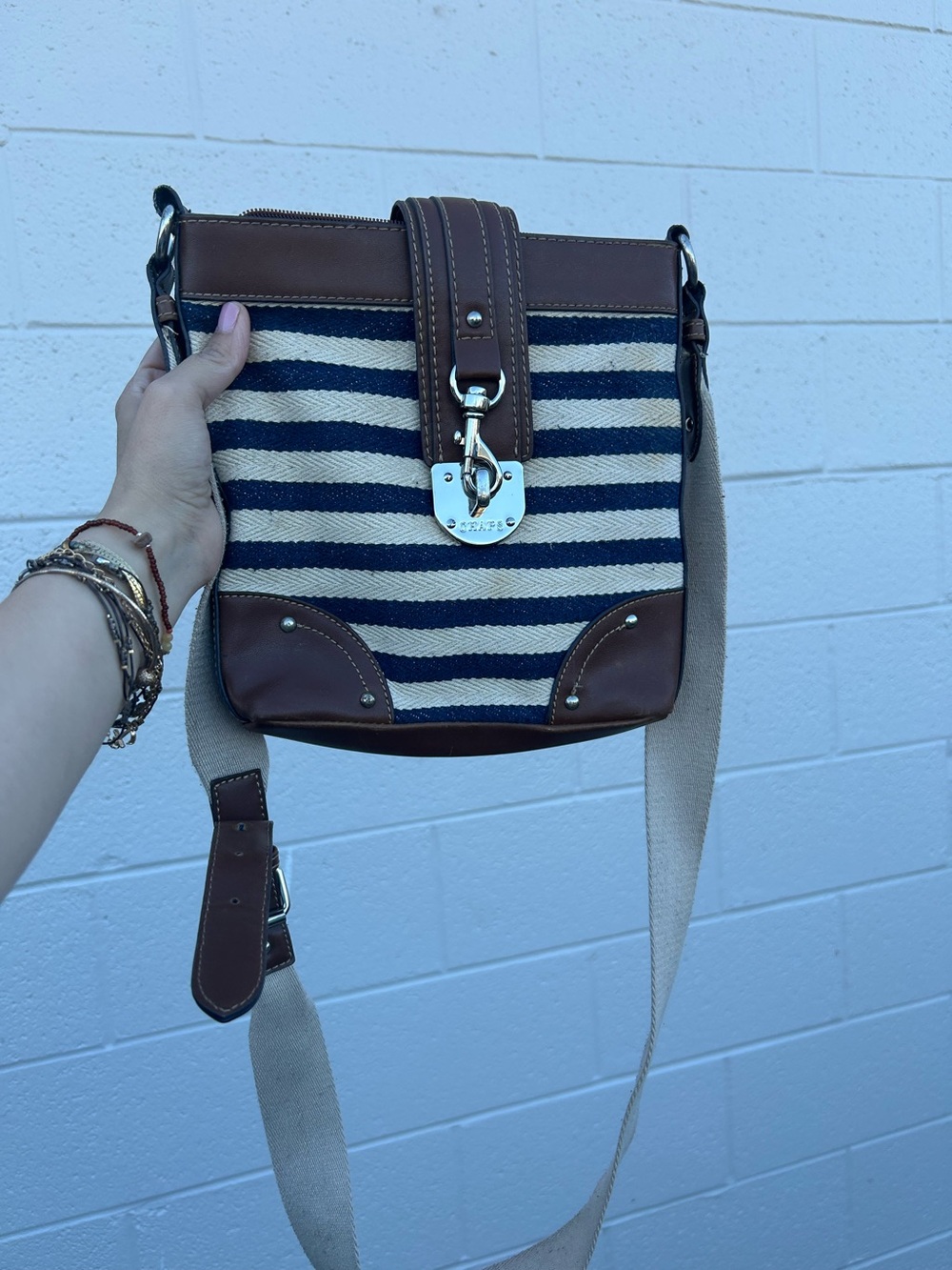 Chaps nautical crossbody bag featuring a navy and white striped canvas body